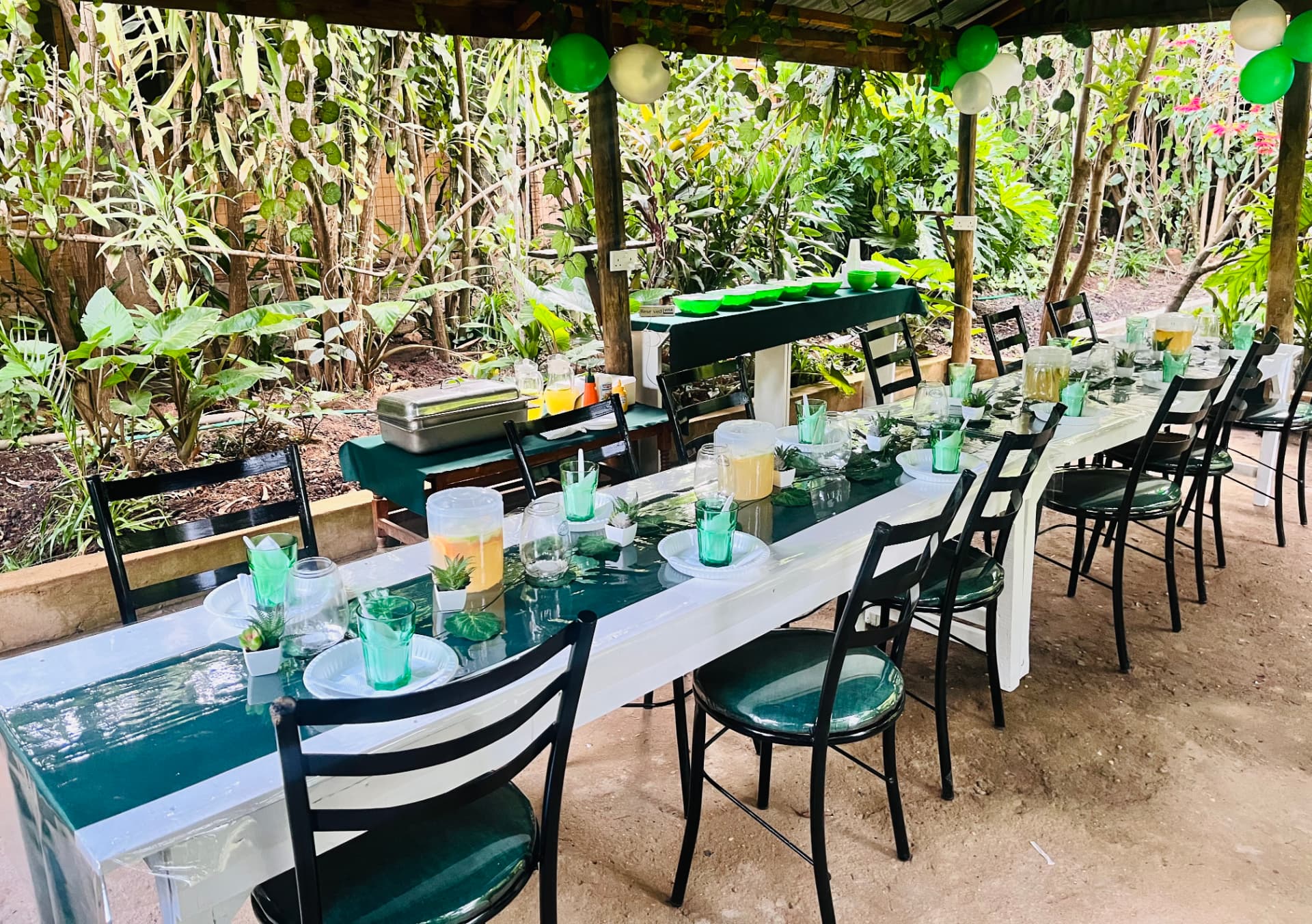 Long table set for a group under the garden shelter